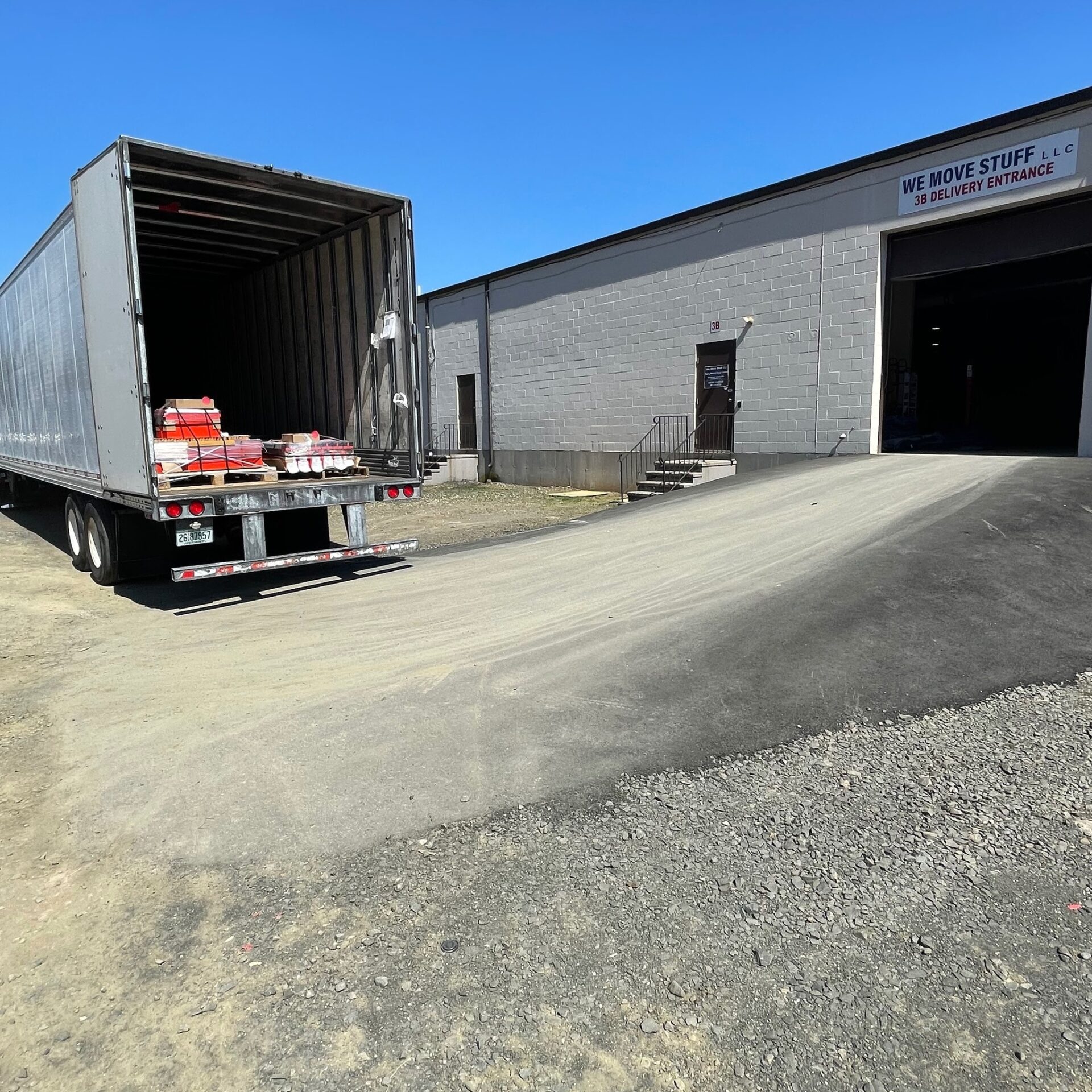 Truck entrance, and trailer delivering to warehouse.